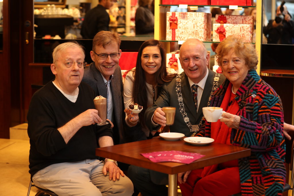 A group of people drinking coffee in a cafe