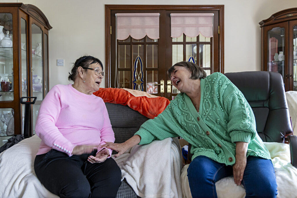An older person spending time with their volunteer visitor.