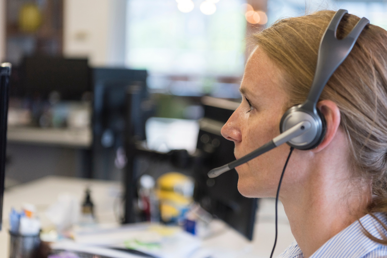 Image of a National Support & Referral Line Volunteer on a phone call to an older person