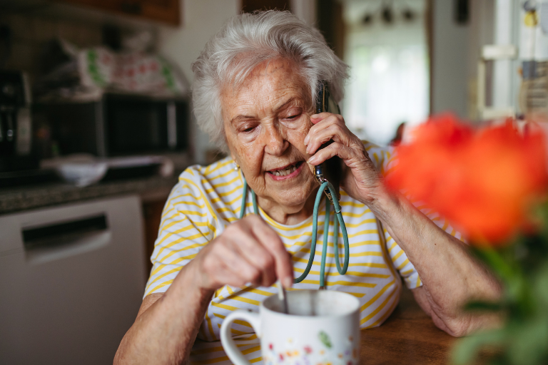 Image of a telephone support volunteer on a phone call to an older person