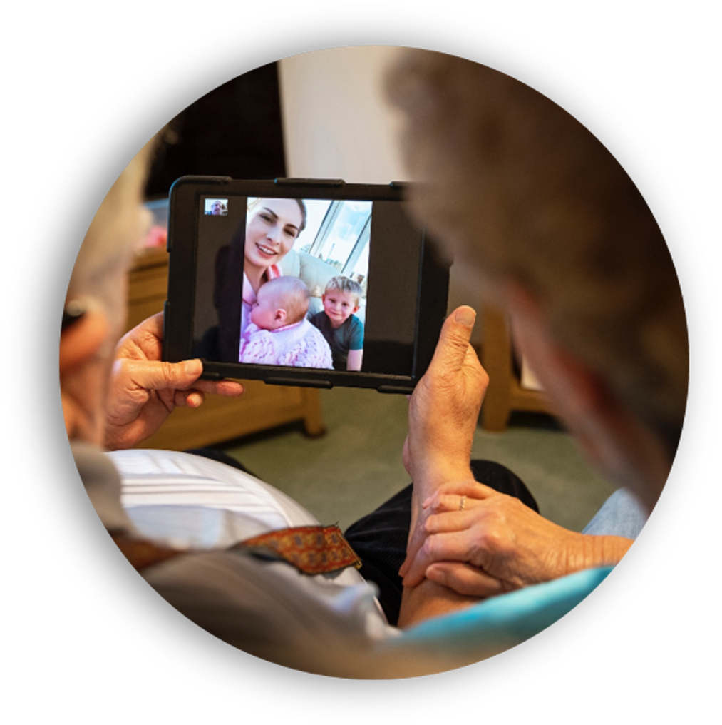 Image of an older person using a tablet device to talk to family